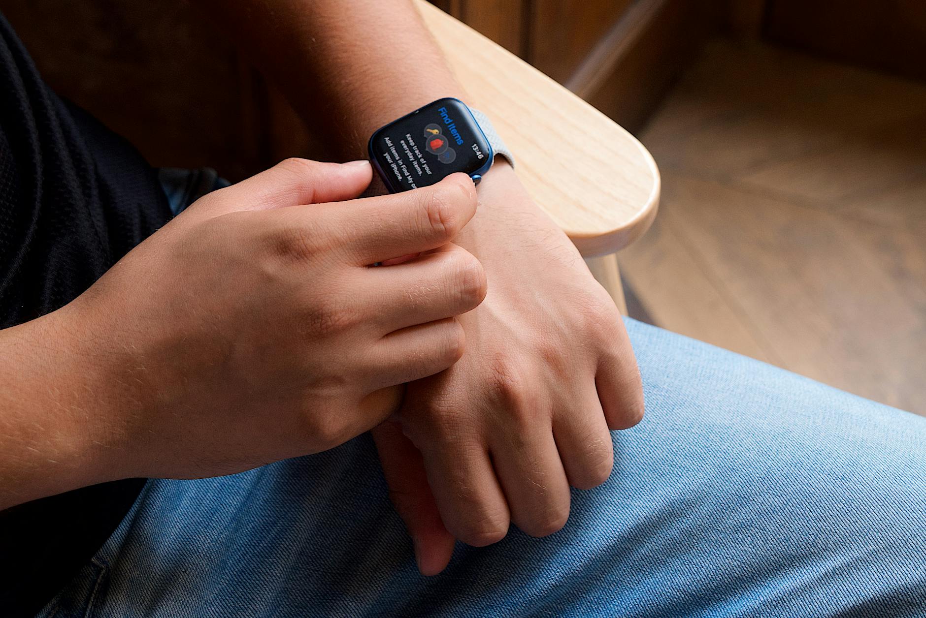 Close-up of a person interacting with a smartwatch, showcasing modern technology and portability.